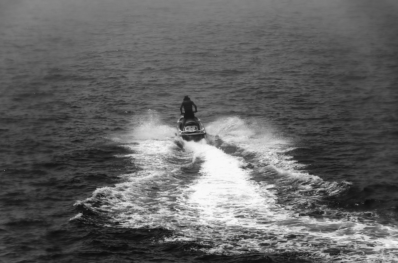Rider on a jet ski crossing Biscayne Bay with the Miami skyline behind